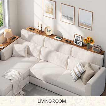 Rustic brown narrow side table with charging station and flip top placed between two living room armchairs.