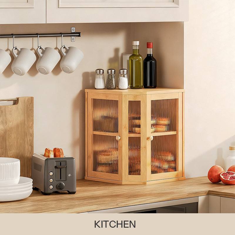 Bamboo corner bread box with ribbed glass doors holding bread on a kitchen countertop next to a toaster.