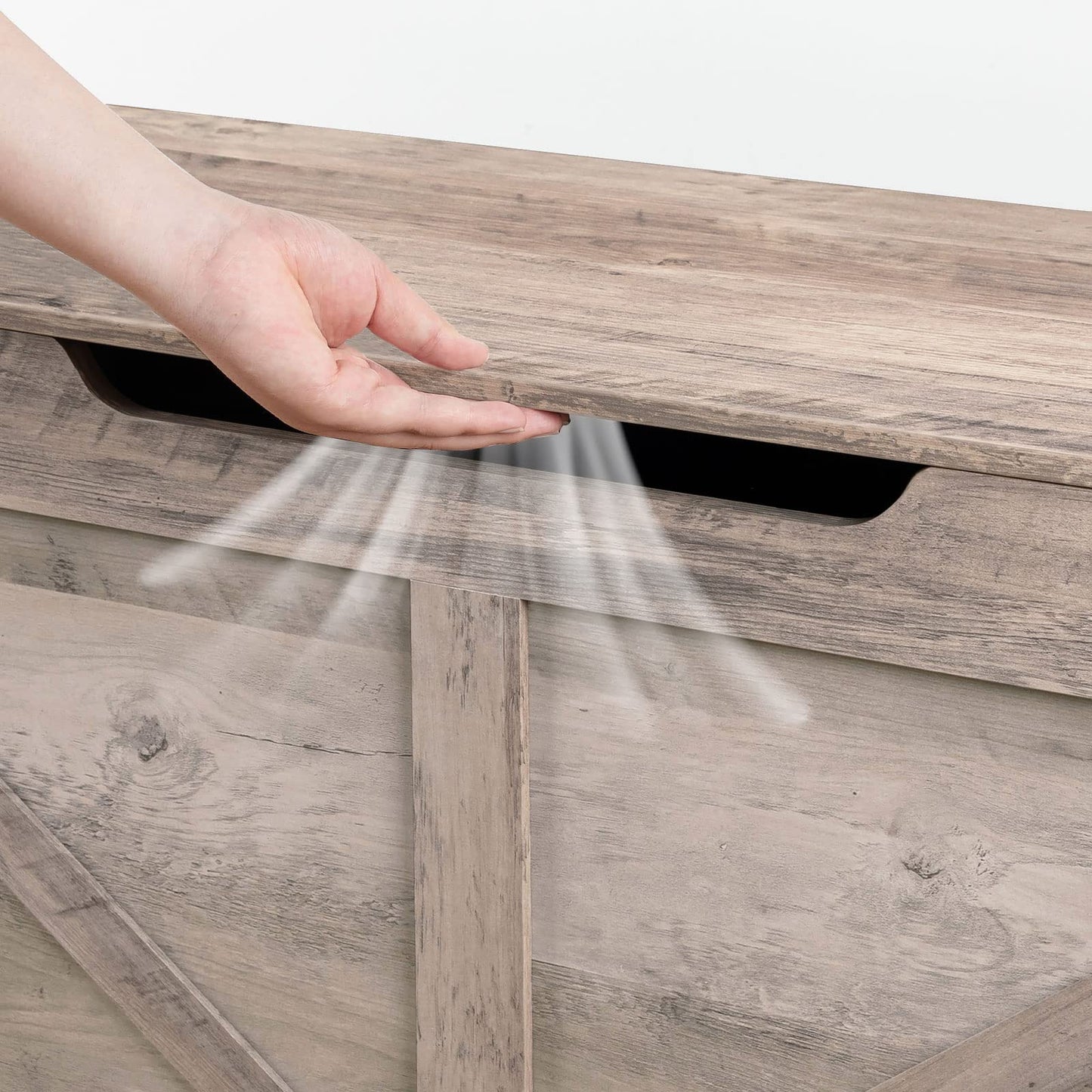Wooden cabinet with a hand opening a compartment, showing a stream of air.