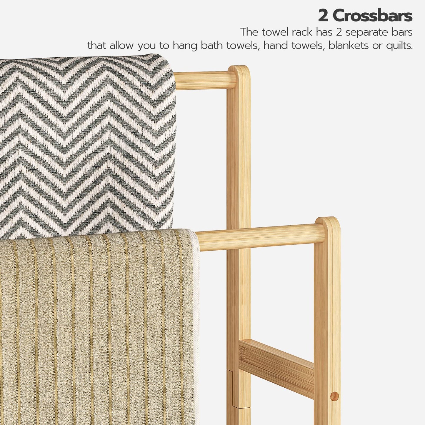 Wooden towel rack with two crossbars holding bath towels on a white background