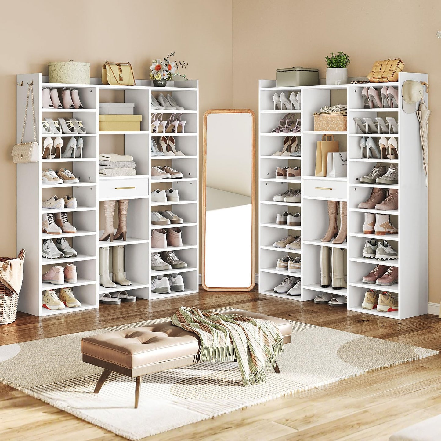 White shoe shelves filled with shoes in a room with a mirror and bench.