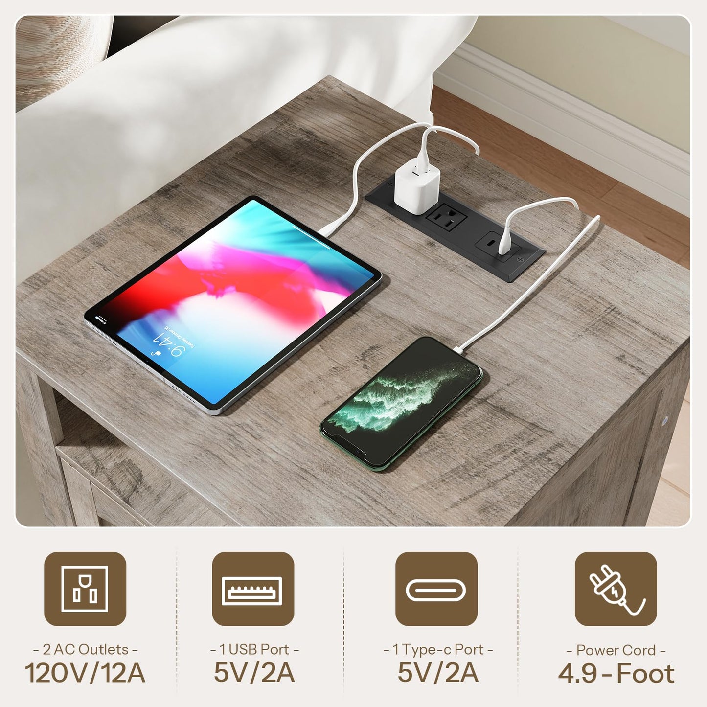 Table with electronic devices and power adapter on a wooden surface