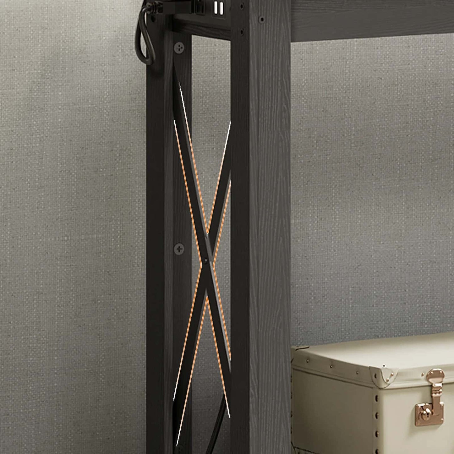Black metal frame with decorative elements against a gray wall.
