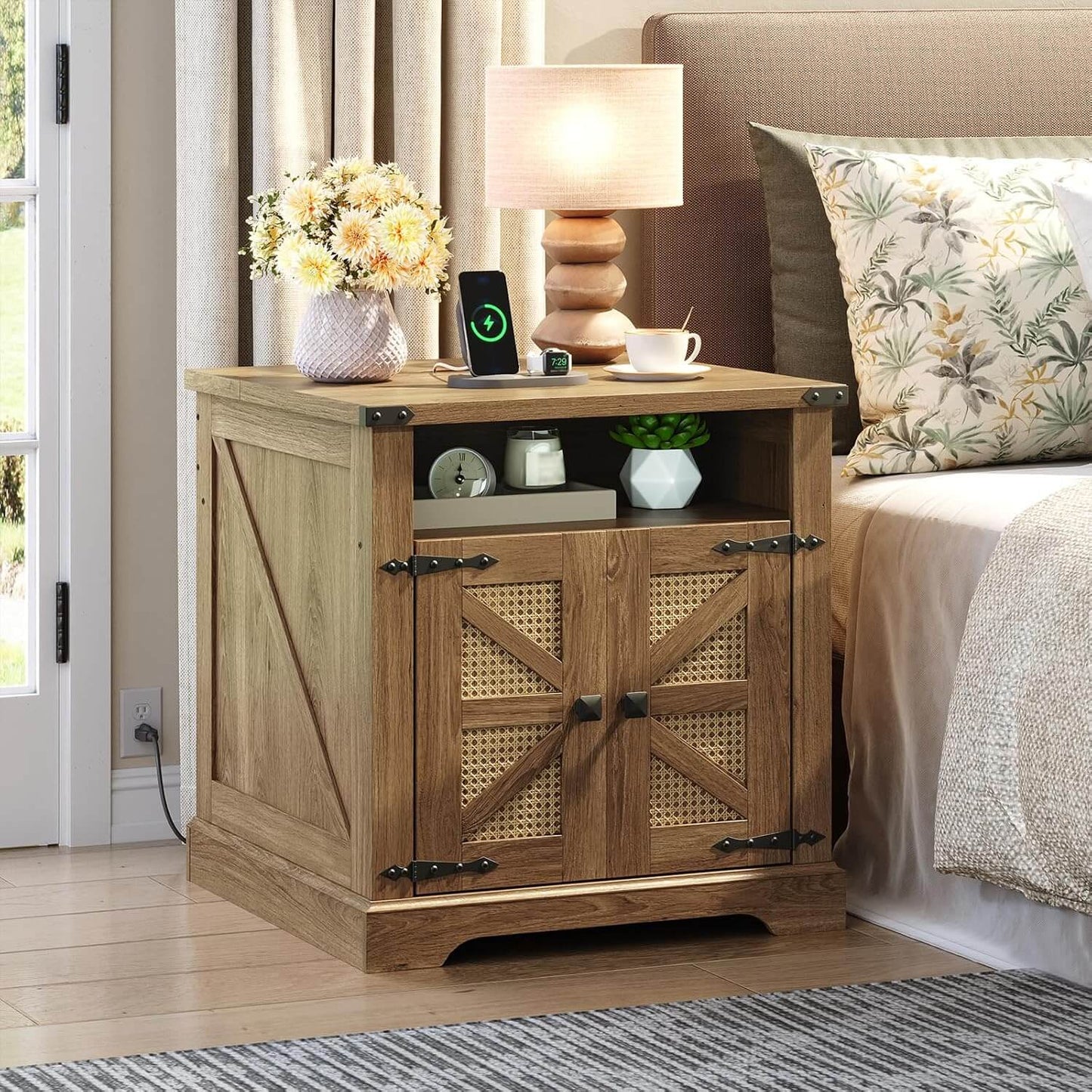 Wooden nightstand with decorative items next to a bed