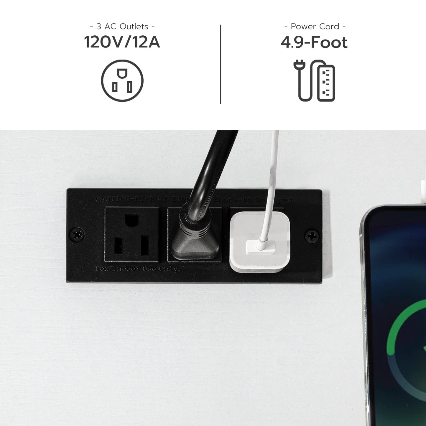 Black power outlet with a cord plugged in, next to a smartphone on a white background.