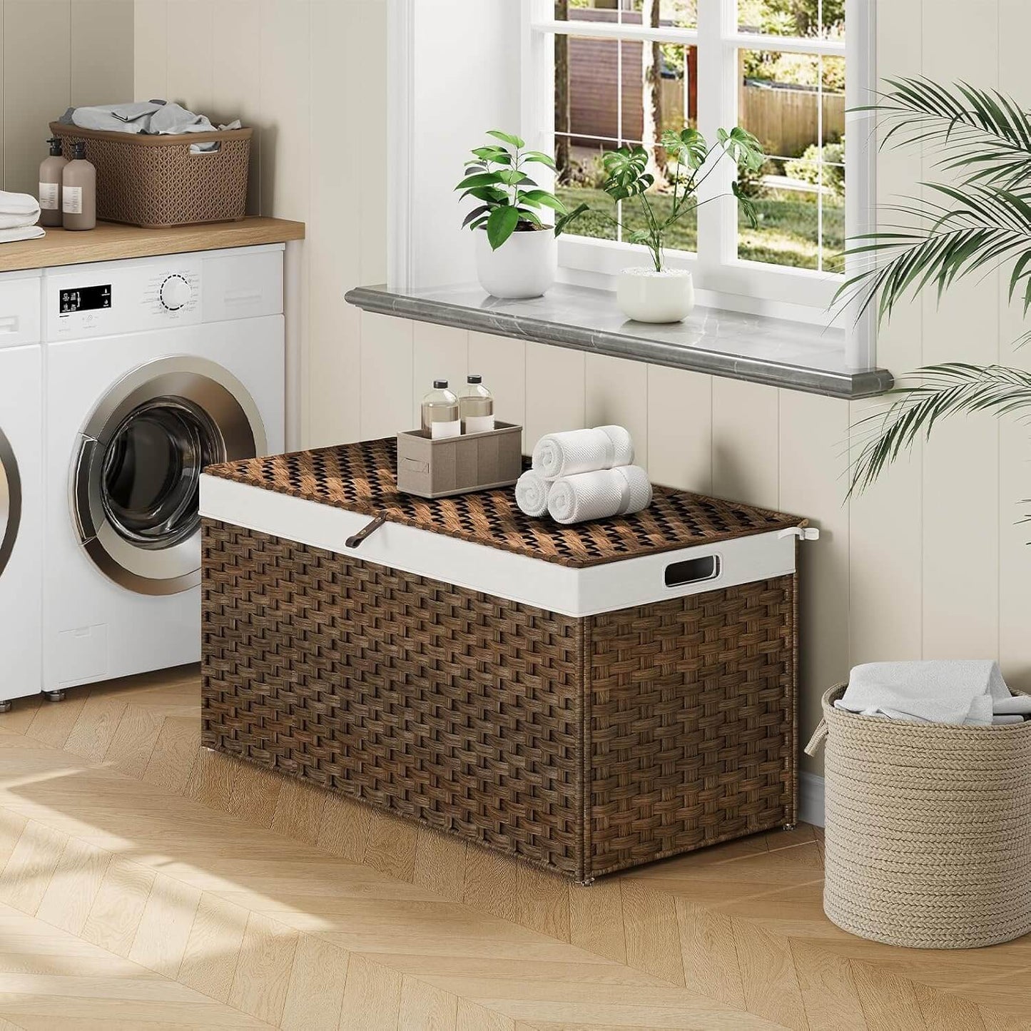 Laundry room with a woven storage basket, washing machine, and towels.