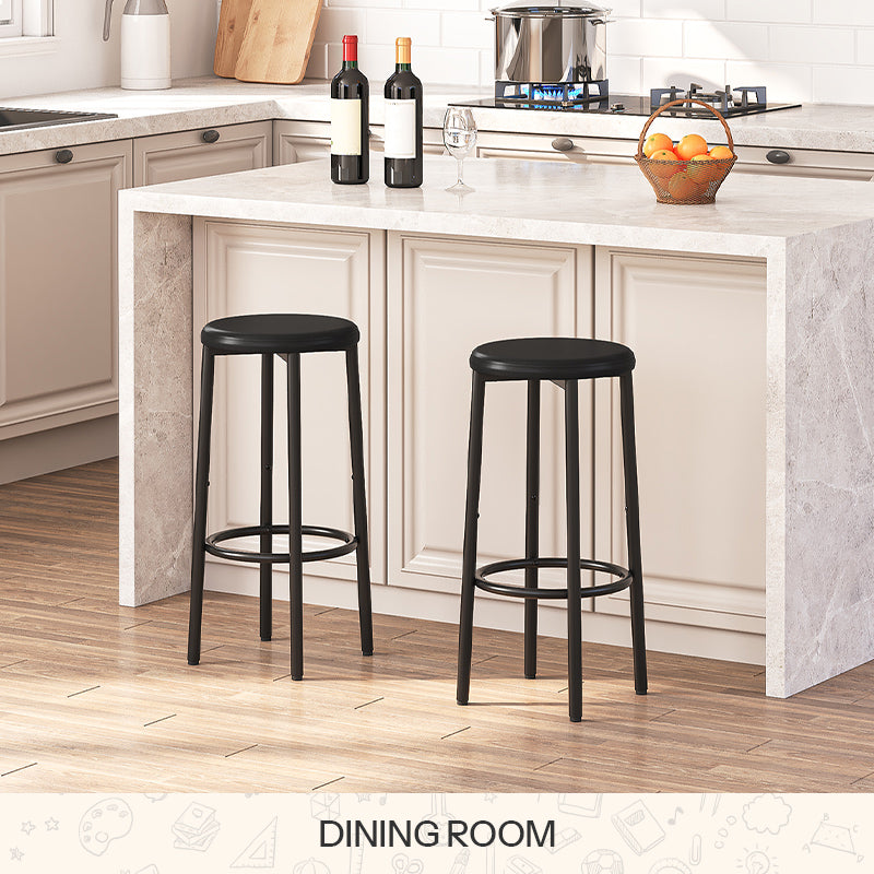 Set of 2 modern black padded bar stools with metal frames placed by a wooden kitchen island bar counter.
