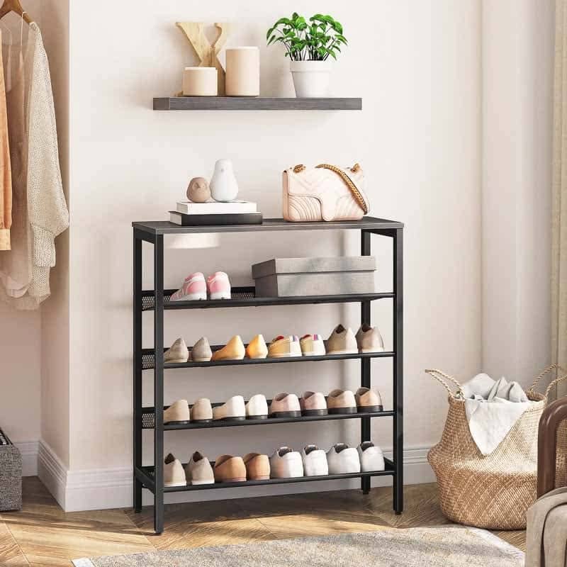 Black shoe rack with shoes on shelves in a room setting.