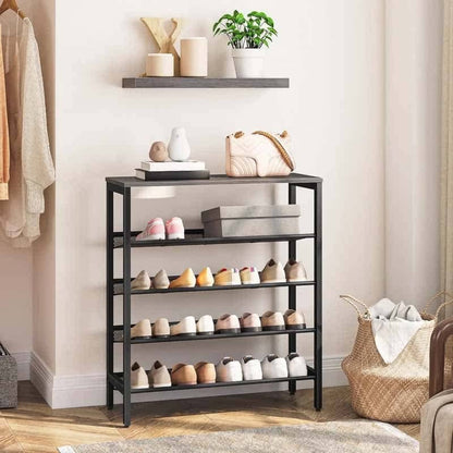 Black shoe rack with shoes on shelves in a room setting.