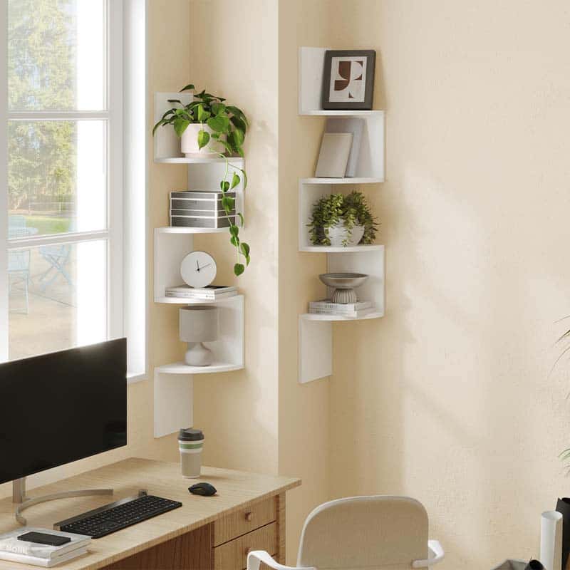 Corner office setup with white wall shelves, desk, chair, and computer monitor.