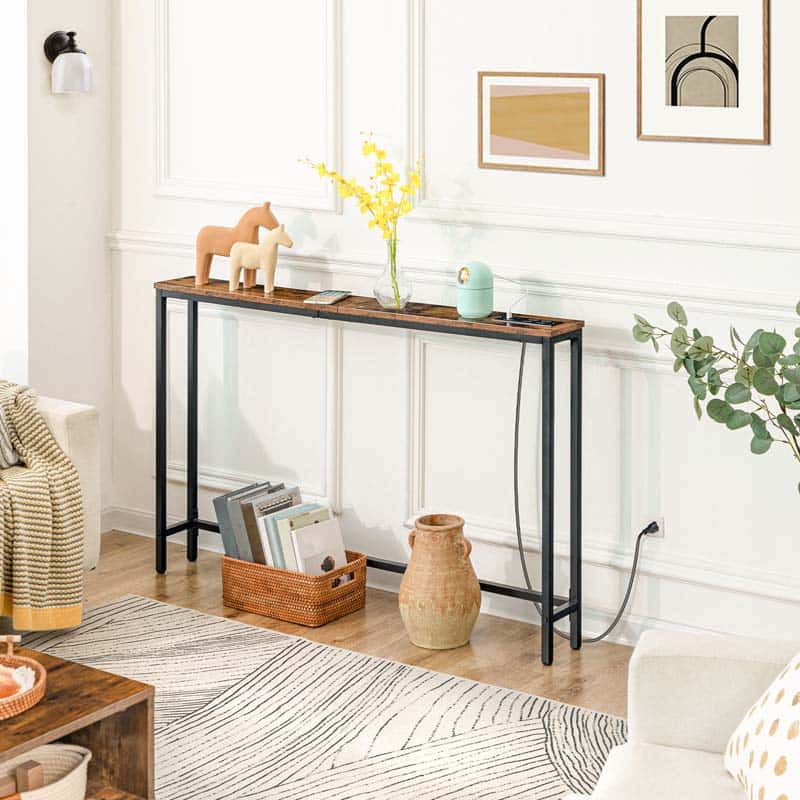 Console table in a living room with decor items and a rug.