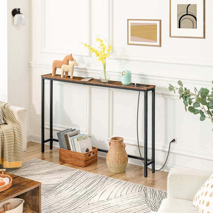 Console table in a living room with decor items and a rug.
