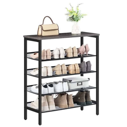 Black shoe rack with various shoes and a handbag on a white background