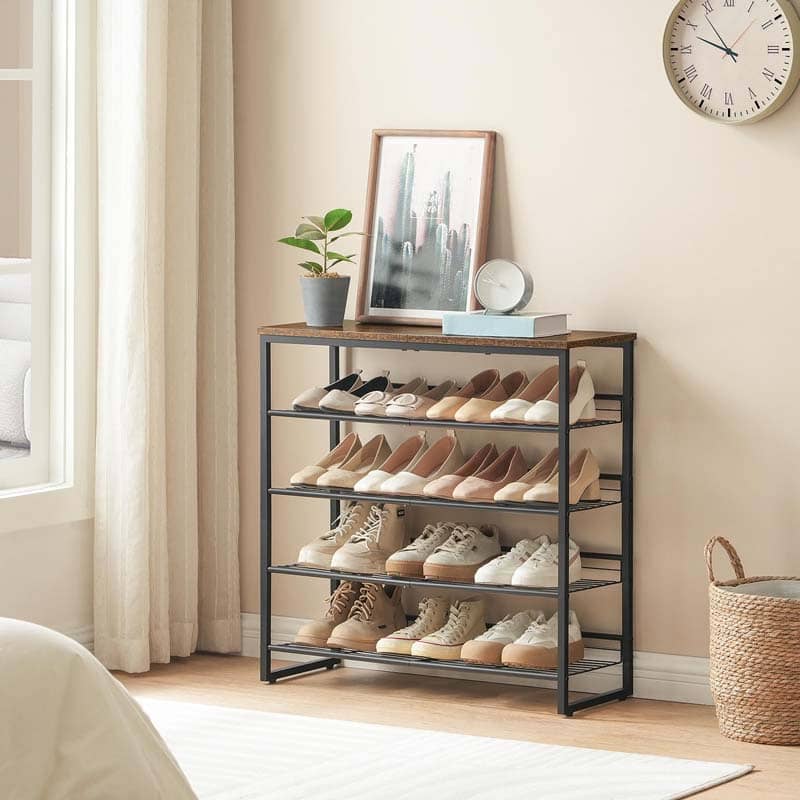 A 4-tier shoe rack with a dark metal frame and a rustic wood top, styled in a bedroom setting with various shoes, a small plant, and decorative items on top.