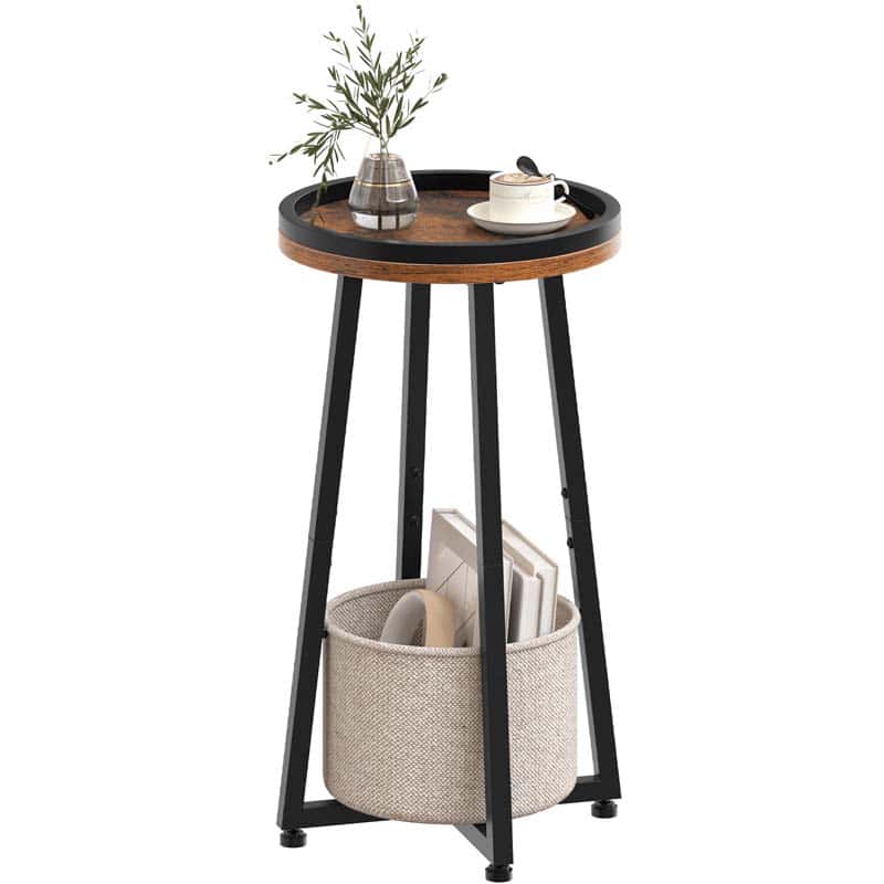 Industrial round side table with a deep cream fabric storage hamper basket holding books on a white background.
