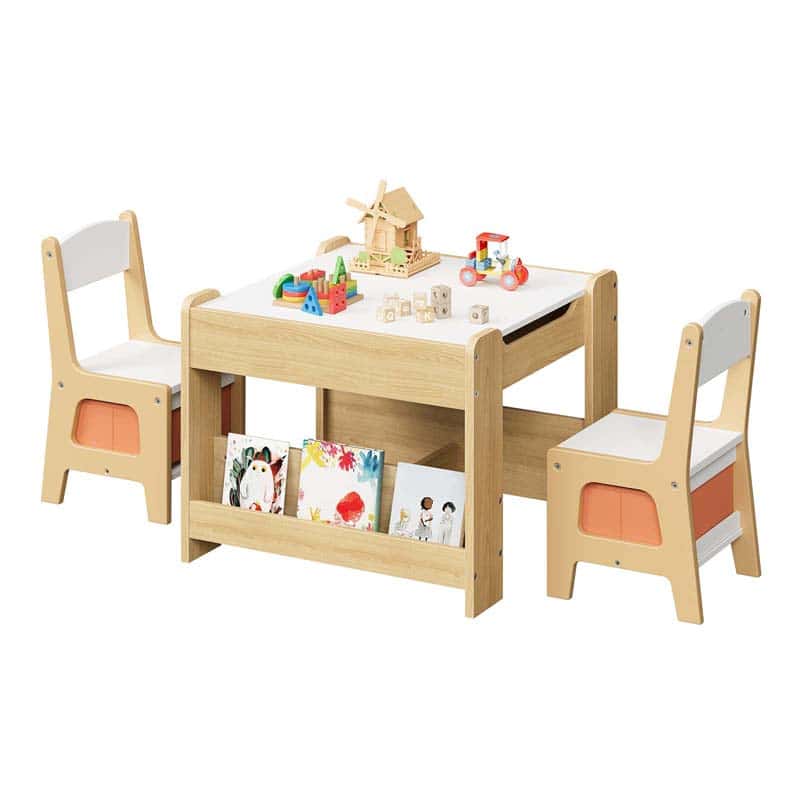Children's wooden table and chairs set with toys and books on a white background