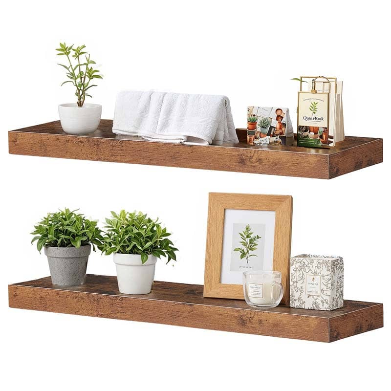 Two pieces of wall-mounted rustic display ledges holding white towels, a photo frame, and small succulent pots.