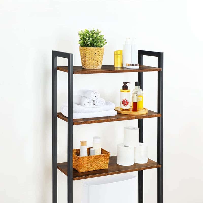 Three-tiered shelf with various items including a plant, towels, and bottles on a white background