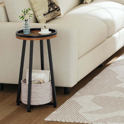 Skinny round sofa side table holding a ceramic tea mug placed next to a modern cream white fabric couch.