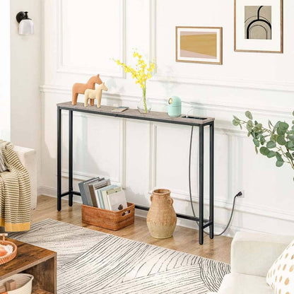 Console table in a living room with decor items and a rug.