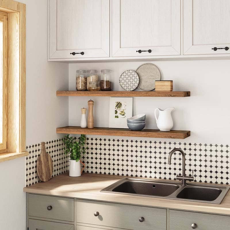 Kitchen wall storage shelves mounted above a sink holding spice jars, plates, and bowls.