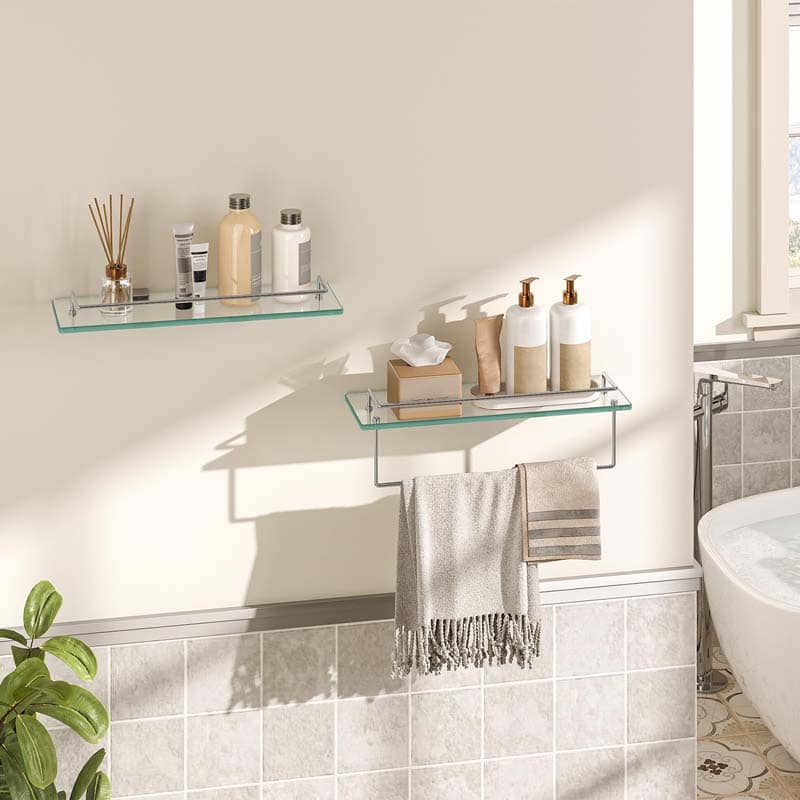 Bathroom with glass shelves holding toiletries and a towel, with a plant and toilet in the background.
