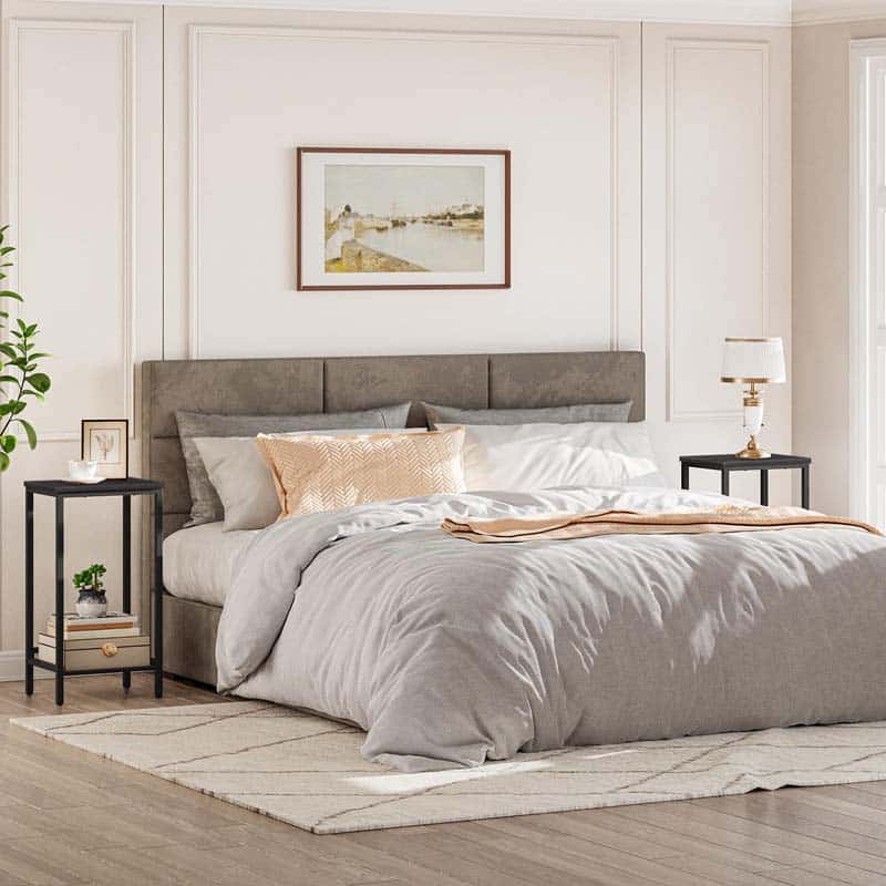 Neatly made bed with gray bedding in a bedroom setting.