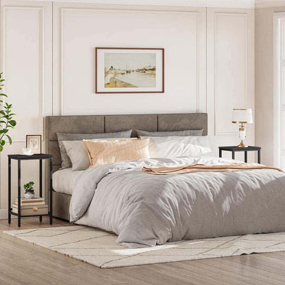 Neatly made bed with gray bedding in a bedroom setting.