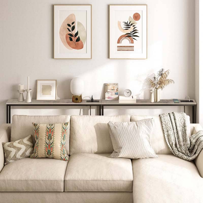 Living room with a beige sofa, decorative pillows, and wall art.