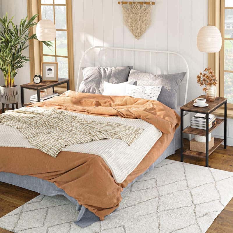 A matching pair of rustic wooden bedroom nightstands setup beside a cozy double bed