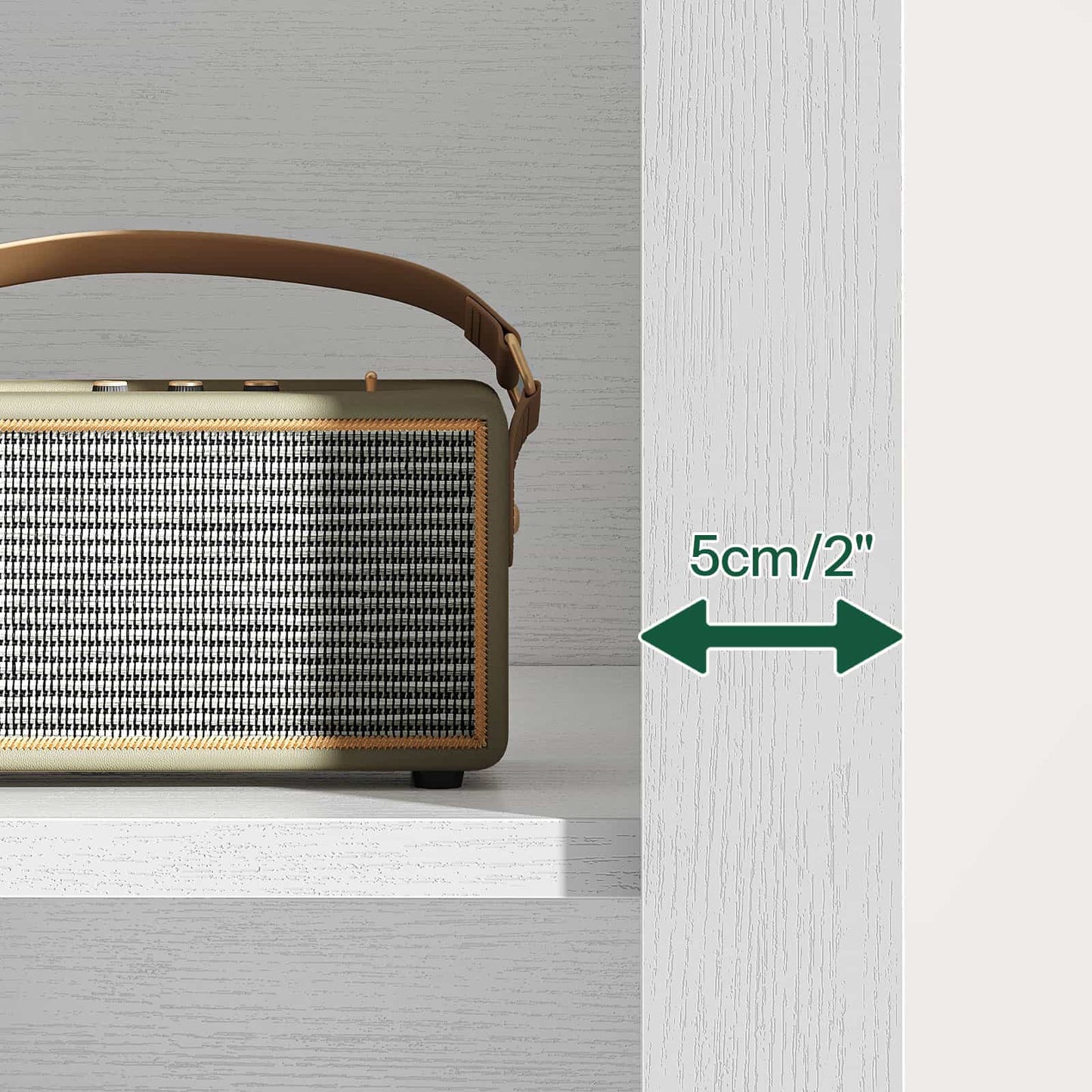Portable radio with a brown handle on a white surface, next to a green arrow indicating 5cm/2".