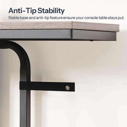 Technical close up demonstrating the console table wall anti-tip safety anchor straps screwed into a wall.