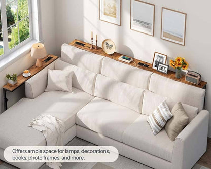 White sectional sofa with wooden shelves and decorative items in a living room.