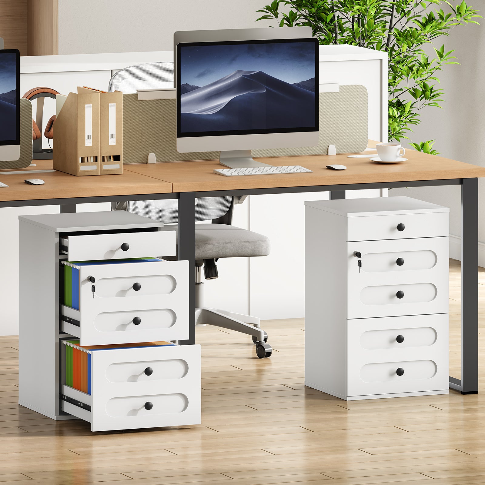 Modern office desk setup with computer, chairs, and storage drawers.