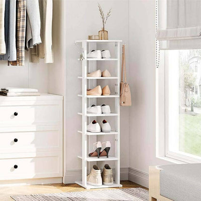 White shoe rack with shoes in a room with a dresser and window.