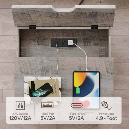 An open storage compartment with a wood-look interior reveals a built-in power outlet and charging setup, with a phone and tablet plugged in. A text overlay at the bottom lists features: 2 AC outlets 120V/12A, 1 USB port 5V/2A, 1 Type-c port 5V/2A, and a power cord 4.