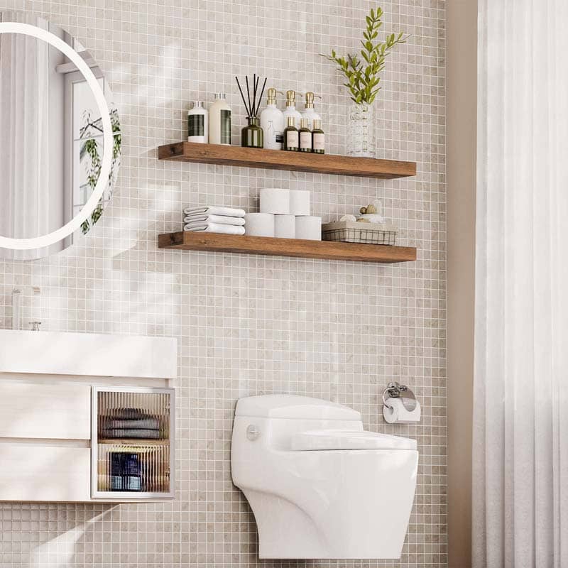 Waterproof rustic floating shelf installed over the toilet in a white modern bathroom holding cosmetics and towels.