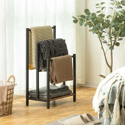 Towel rack with folded towels in a room with a plant and basket.