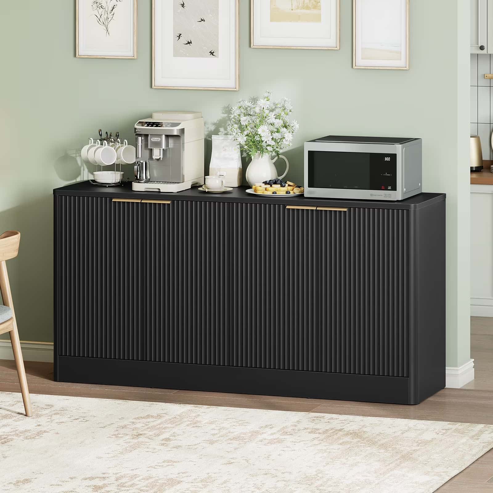 Black sideboard with kitchen appliances against a light green wall.