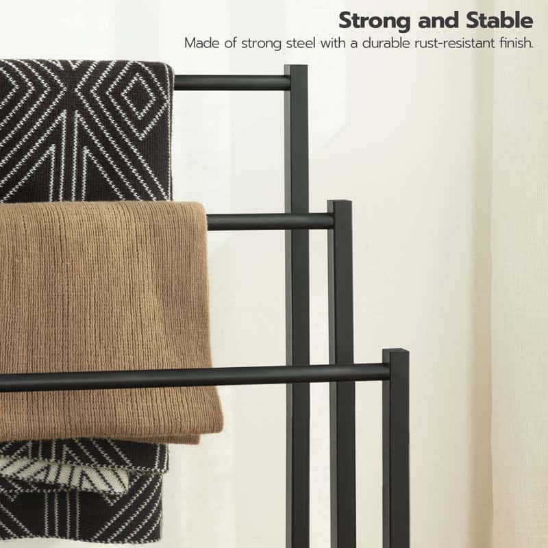 Black metal towel rack with towels on a white background, text indicating strength and stability.