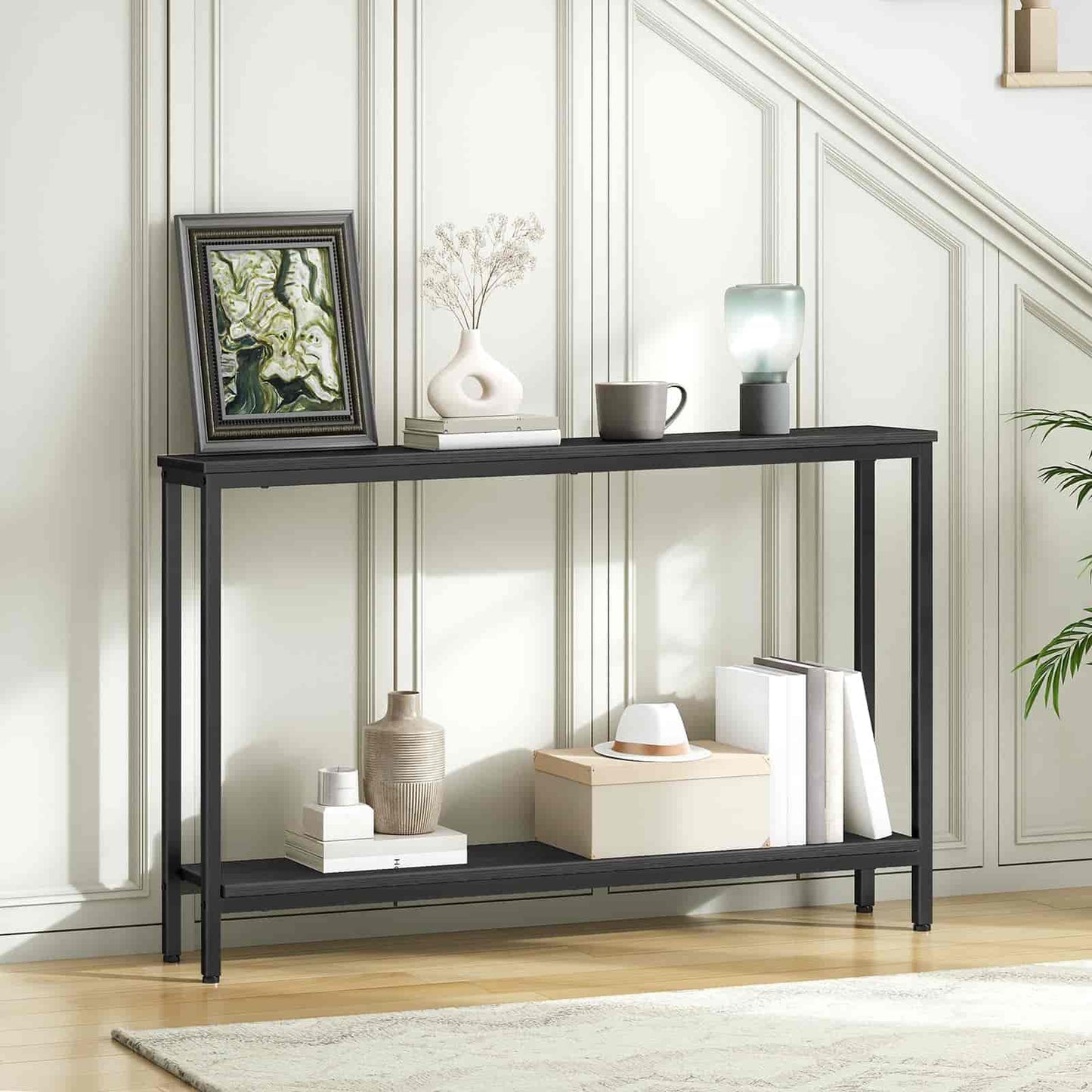 Black console table with decorative items against a white wall