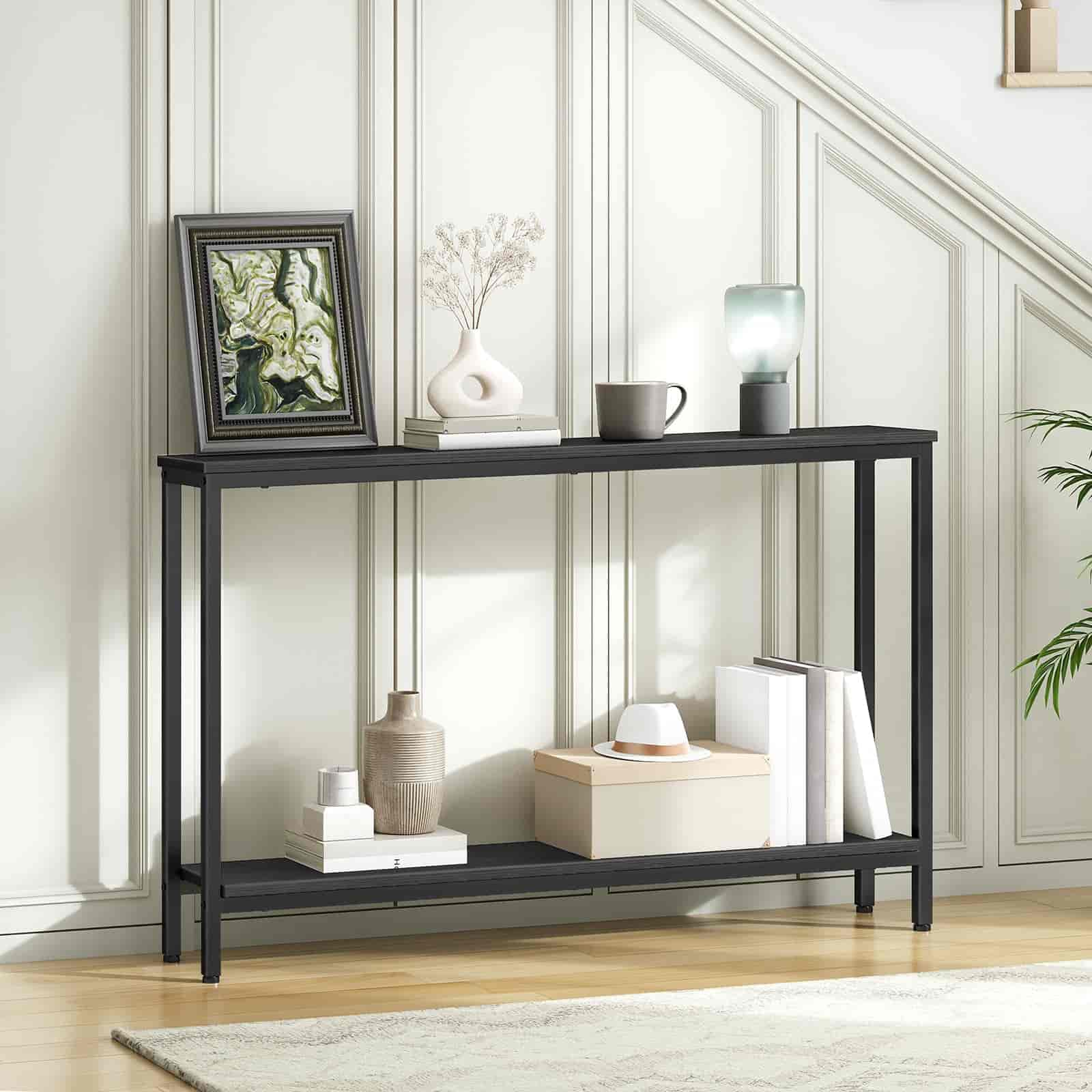 Black console table with decorative items against a white wall
