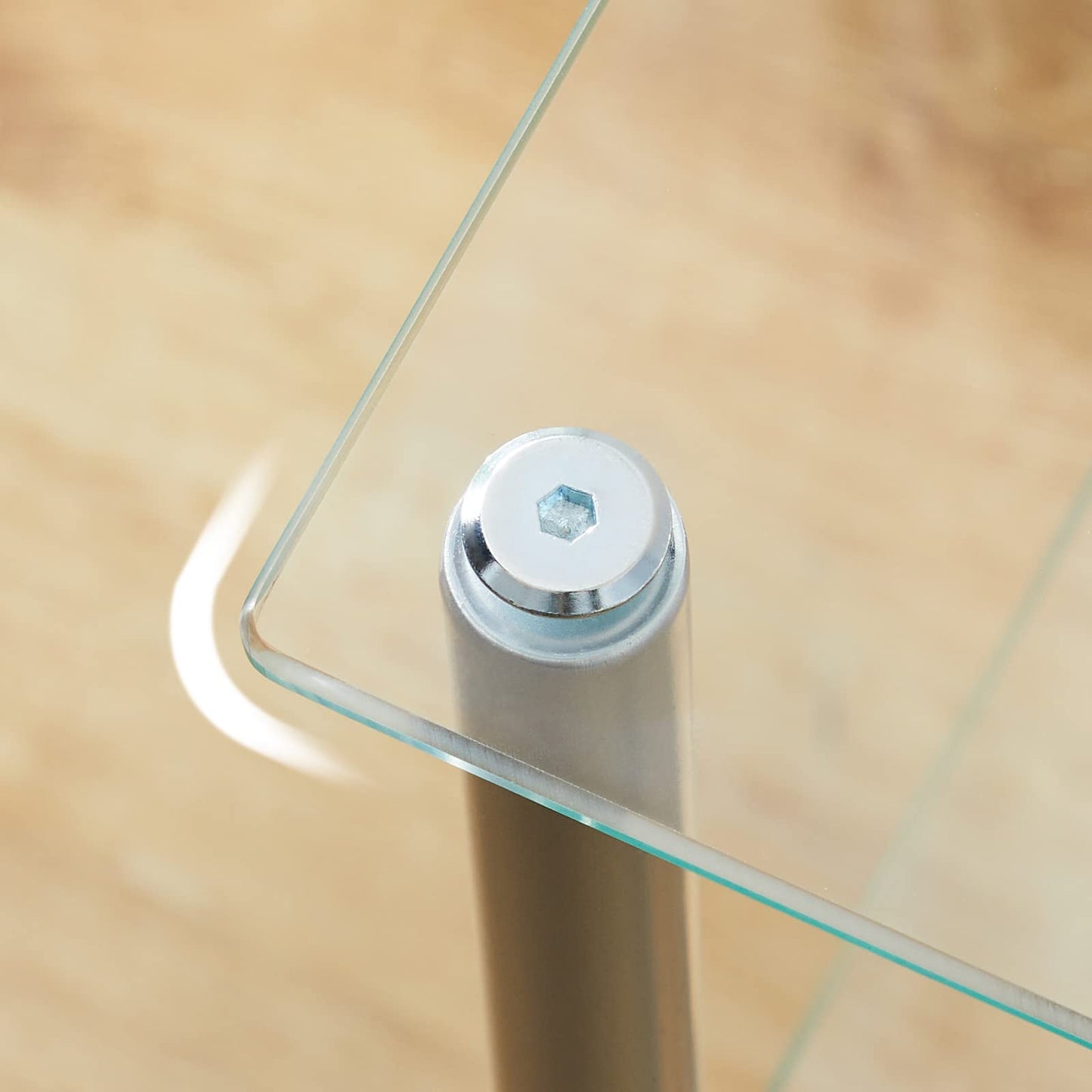 Glass table with metal leg on a wooden floor