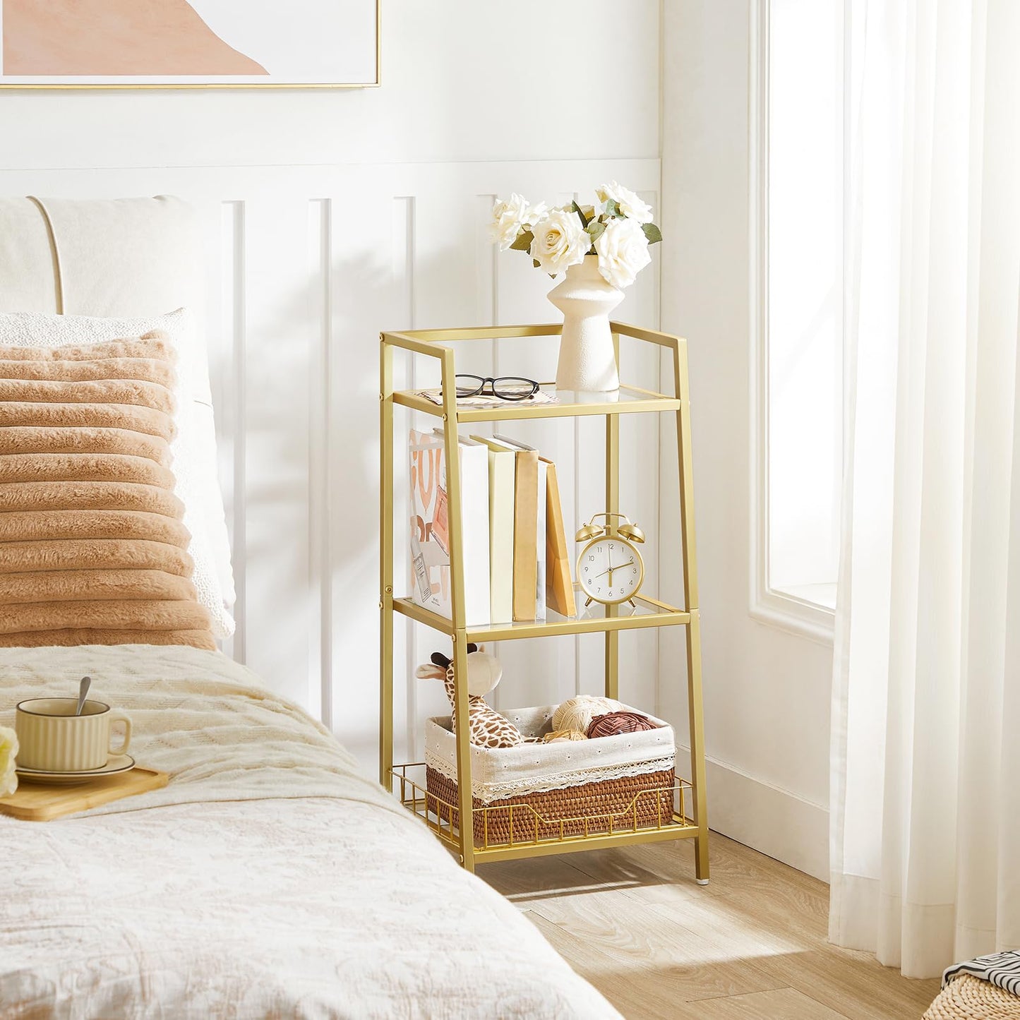 Gold side table with decorative items in a bedroom setting