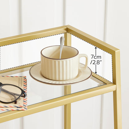 Gold-framed glass table with a beige cup and saucer on a white background
