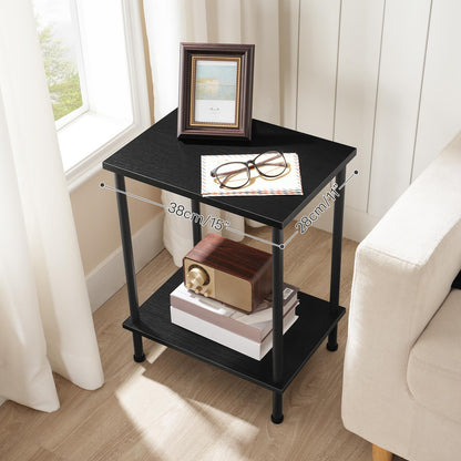 Black side table with books, glasses, and a picture frame in a room with a window and chair.