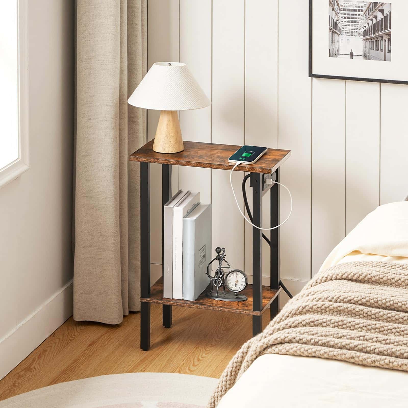 Wooden nightstand with lamp and electronic devices in a bedroom setting