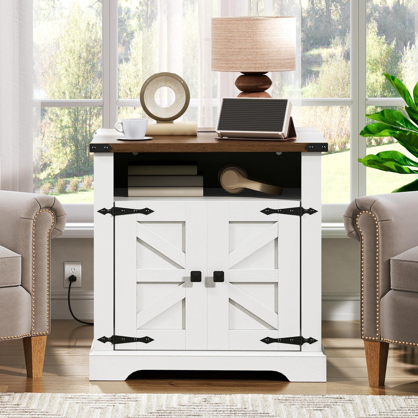 White entertainment console with wooden top in a room with chairs and a lamp.