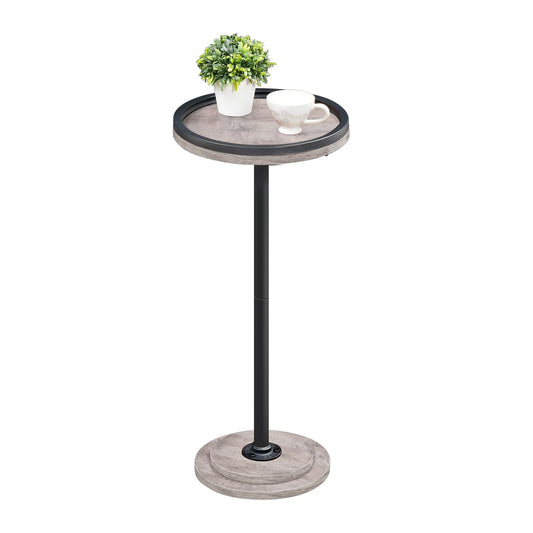 Small round side table with a plant and cup on a white background