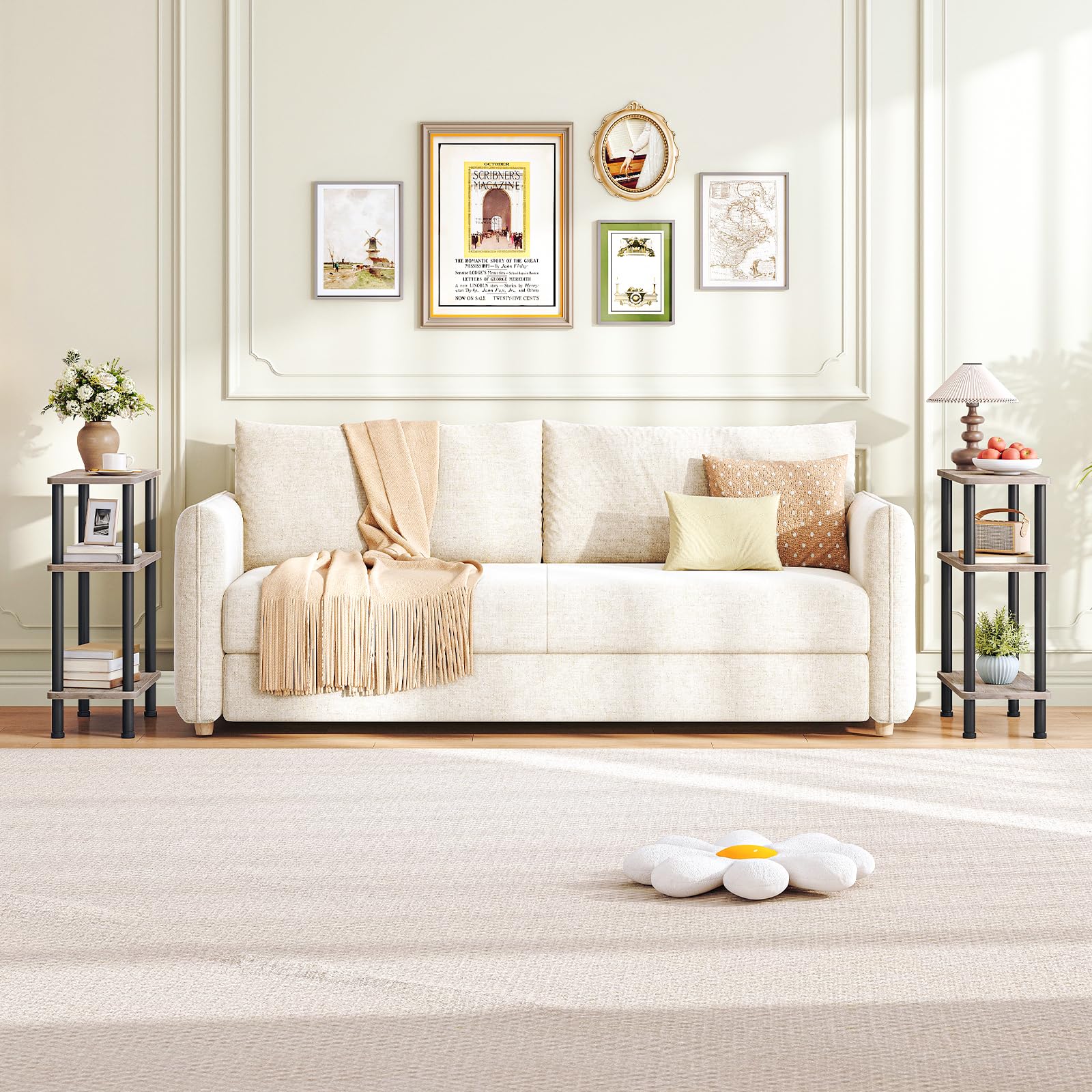 Living room with a white sofa, decorative pillows, and framed pictures on the wall.